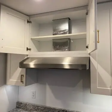 Kitchen cabinet and range-hood installation in progress