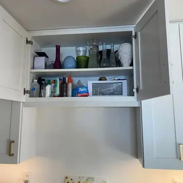 Storage cabinet above a finished kitchen range hood